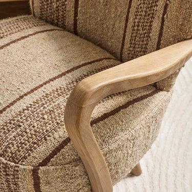 CALVIN IN BROWN STRIPED RUG